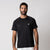Gray background, image of a male model wearing the JOOLA Men's Court Short Sleeve shirt, black.