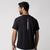 Gray background, image of the back of a JOOLA Men's Court Short Sleeve shirt, black with white logos.