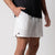 Close up image of the JOOLA trinity logo on the side of a pair of JOOLA Men's Woven Shorts, white.