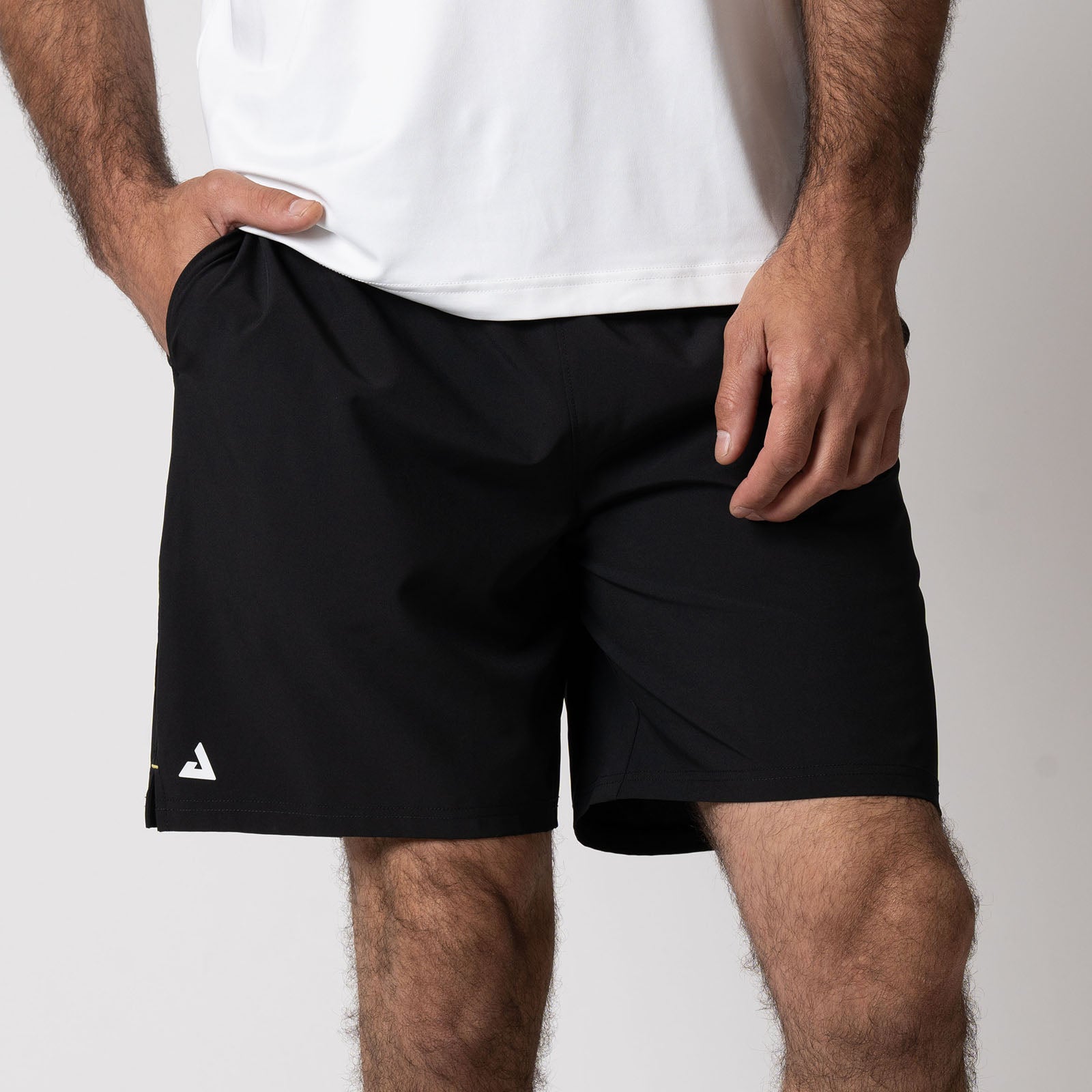 Close up image of a male model wearing a pair of JOOLA Men's Woven Shorts, 7-inch inseam, black.