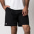 Close up image of a male model wearing a pair of JOOLA Men's Woven Shorts, 7-inch inseam, black.