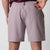 Close up image showing the back zipper pocket and JOOLA logo on the waistband of a pair of JOOLA Men's Woven Shorts, 7 inch inseam, dusty mauve.
