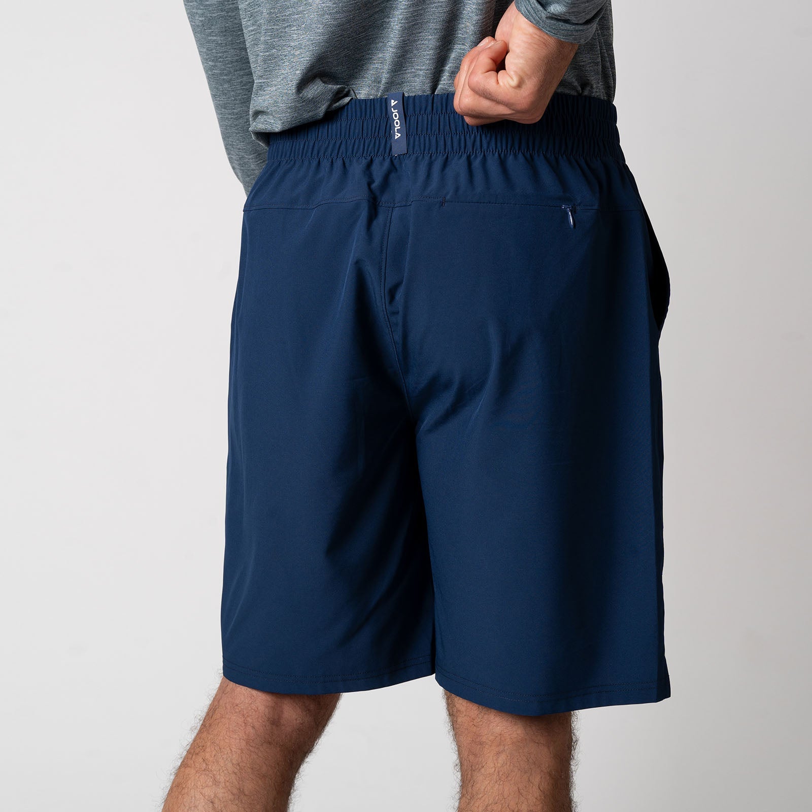 Image showing the back of a pair of JOOLA Men's Woven Shorts with a Nine-inch inseam, navy.