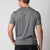 Image showing the back of a male model who is wearing a JOOLA Men's Club Short Sleeve Shirt, Charcoal Heather.