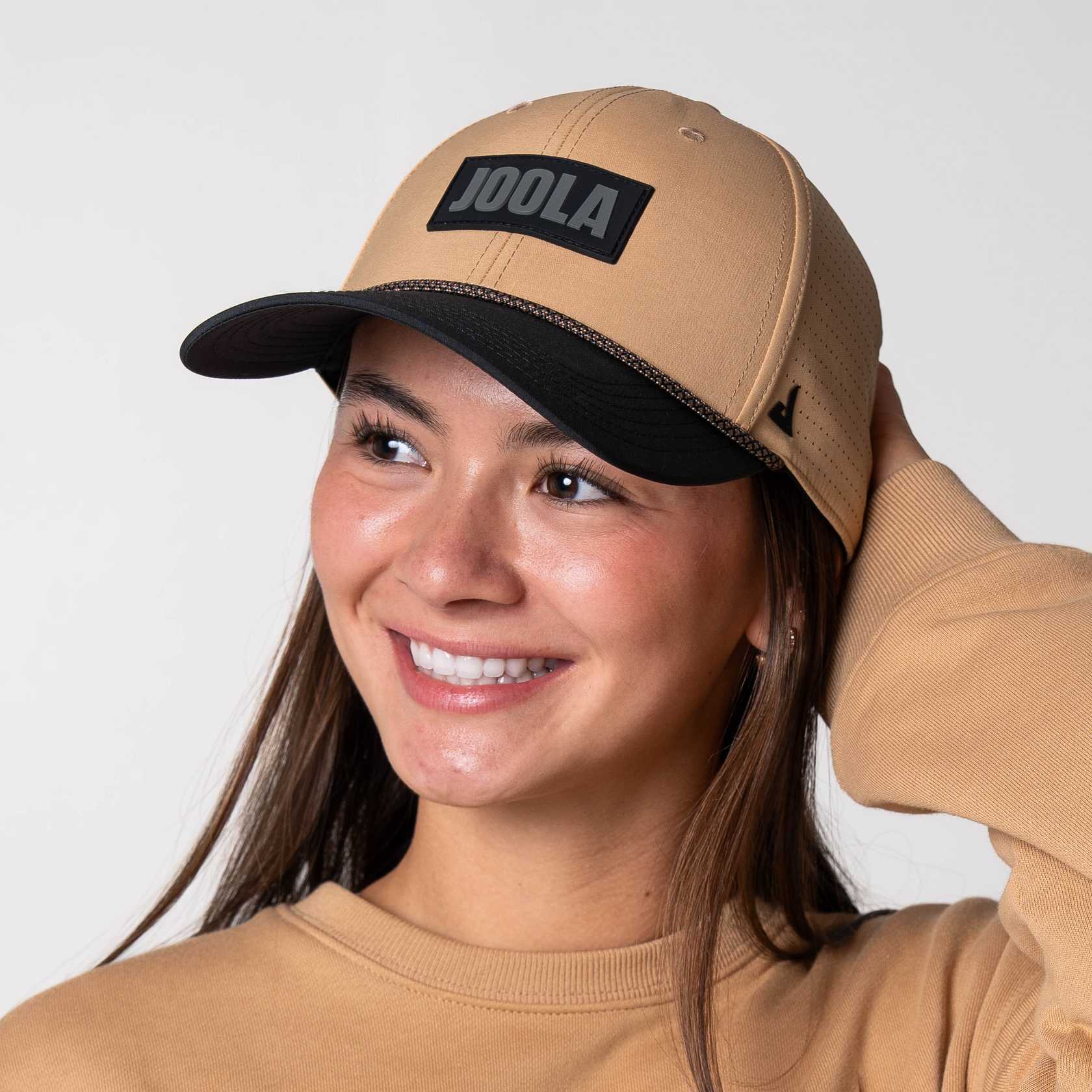 Female model wearing JOOLA Rope Cap, latte colored with black bill and JOOLA Branding.