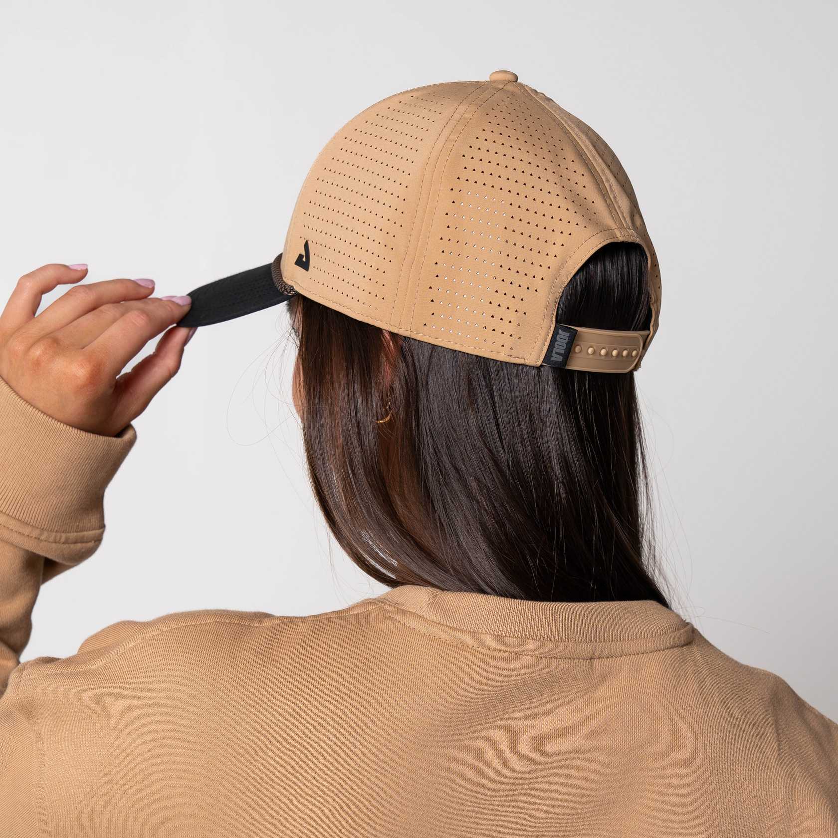 Image showing a femaled model wearing the JOOLA Rope Cap, latte colored with black bill and JOOLA Branding.
