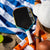 The JOOLA Perseus Summer Daze Pickleball paddle with black surface, orange, blue, green and yellow color gradient on the rim, and white handle.