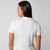 Image showing the back of a female model who is wearing a JOOLA women's club polo, white.
