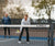 Image of the JOOLA Pro Pickleball net in the foreground of the image and Andre Agassi and Stefi Graf in the background.